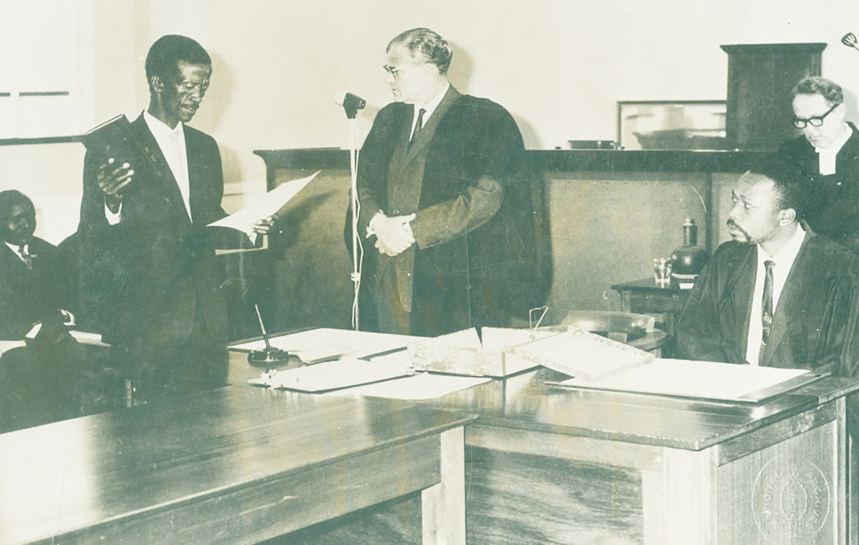 Legislative Council (LEGCO) – 1964: (L – R: Seated – Mr. Polycarp Dlamini; (Standing) holding a Bible – Mr. Abednigo Kuseni Hlophe and Hon. I.B. (Standing); Mr. O.Z. Dlamini (Seated - R); Hon. Arnout Germond – First Speaker of the Legislation Council (Behind)